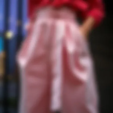 Close-up of the unique design features of belted paperbag pants, highlighting fabric texture