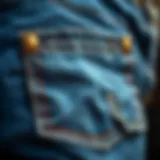 Close-up view of a denim flap pocket showcasing intricate stitching and design.