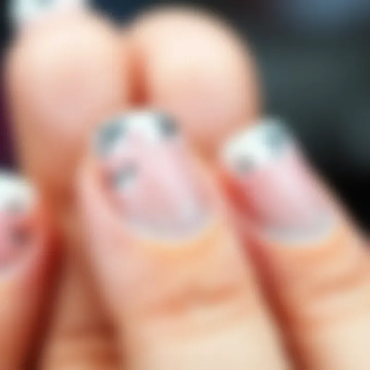 Close-up view of beautifully applied French manicure with stickers