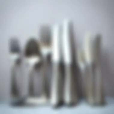 Variety of matte stainless steel flatware designs displayed on a neutral background.
