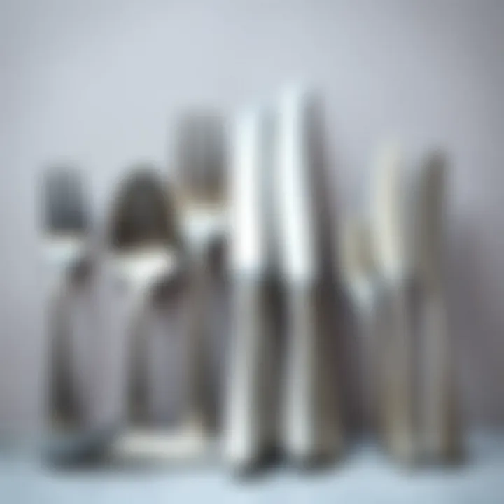 Variety of matte stainless steel flatware designs displayed on a neutral background.