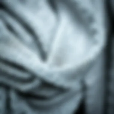 Intricate Texture of Silver Metallic Scarves A close-up of an intricate silver metallic scarf showcasing its shimmering texture.