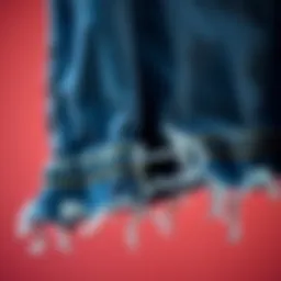 A close-up of a frayed hem detail on denim fabric