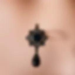 Elegant black goth belly button ring with intricate design.