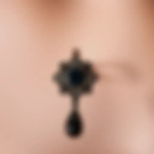 Elegant black goth belly button ring with intricate design.