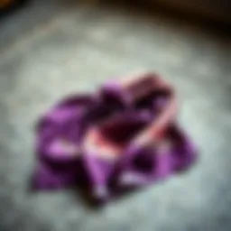 A luxurious mulberry silk bandana draped elegantly on a textured surface