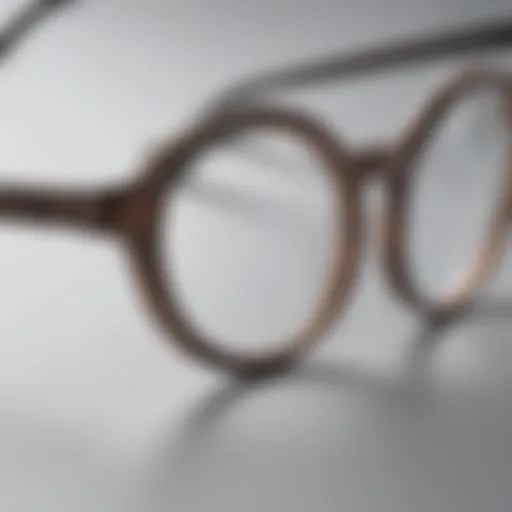 A close-up of small oval eyeglass frames showcasing intricate design details