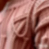 A close-up of a beautifully ripped knitted sweater showcasing the craftsmanship and intricate detailing